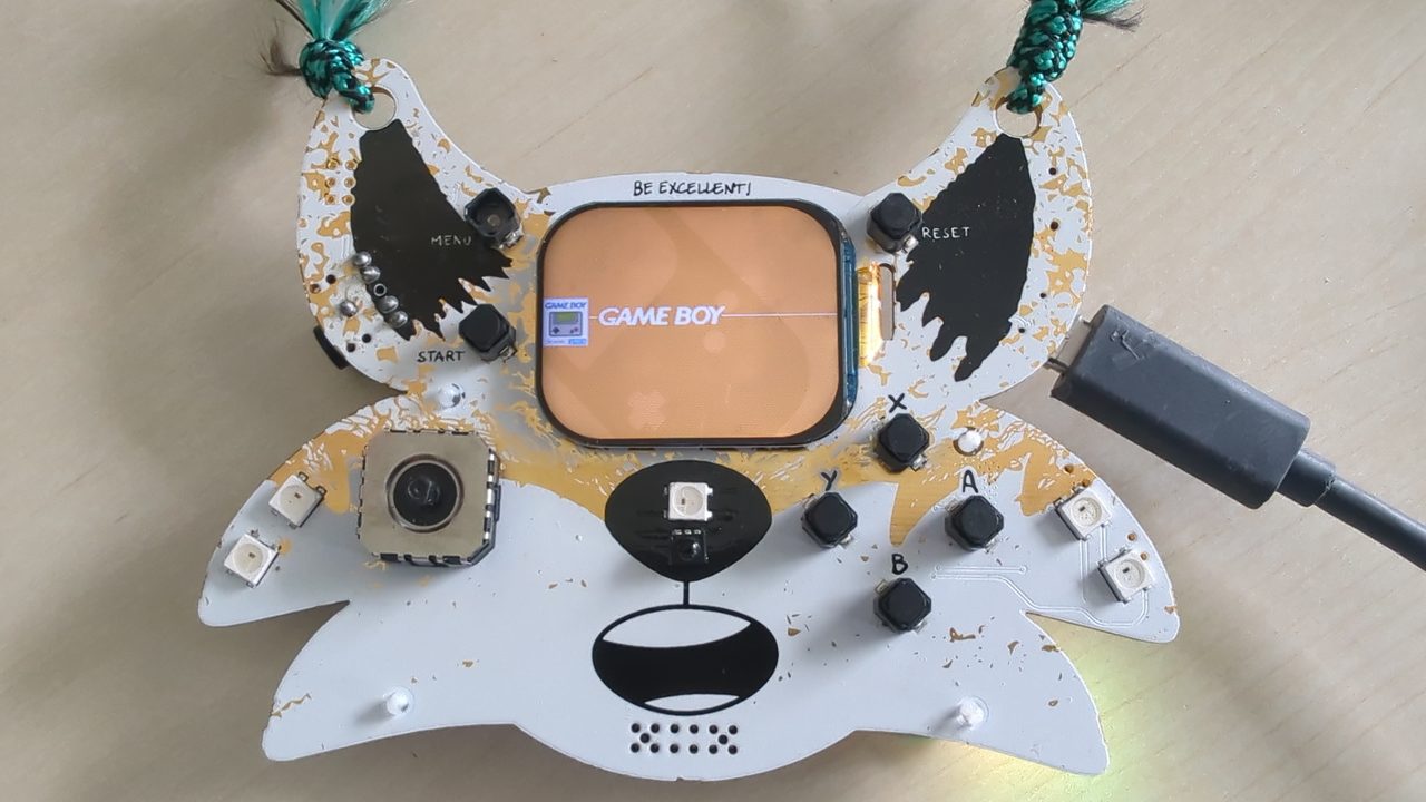 Back of the badge — the silkscreen documents every GPIO