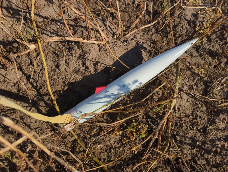 The nose cone lying in the field