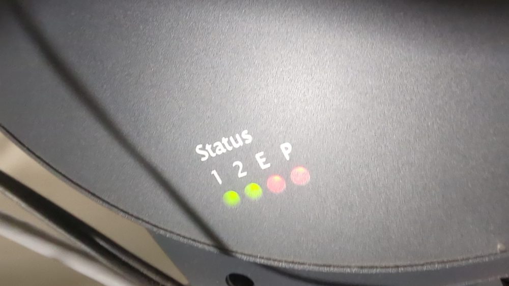 Close-up of the four front-panel status LEDs labelled P, 1, 2 and E
